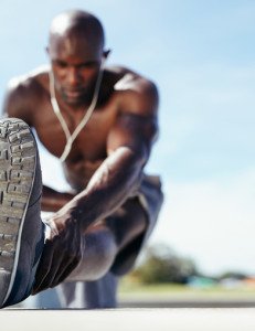 Male athlete stretching his leg muscles